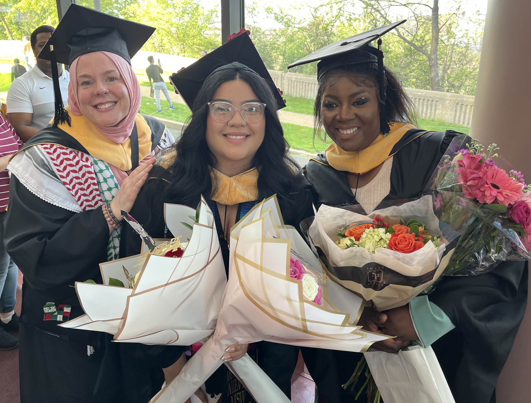 Three Title IV-E students celebrate their graduation.